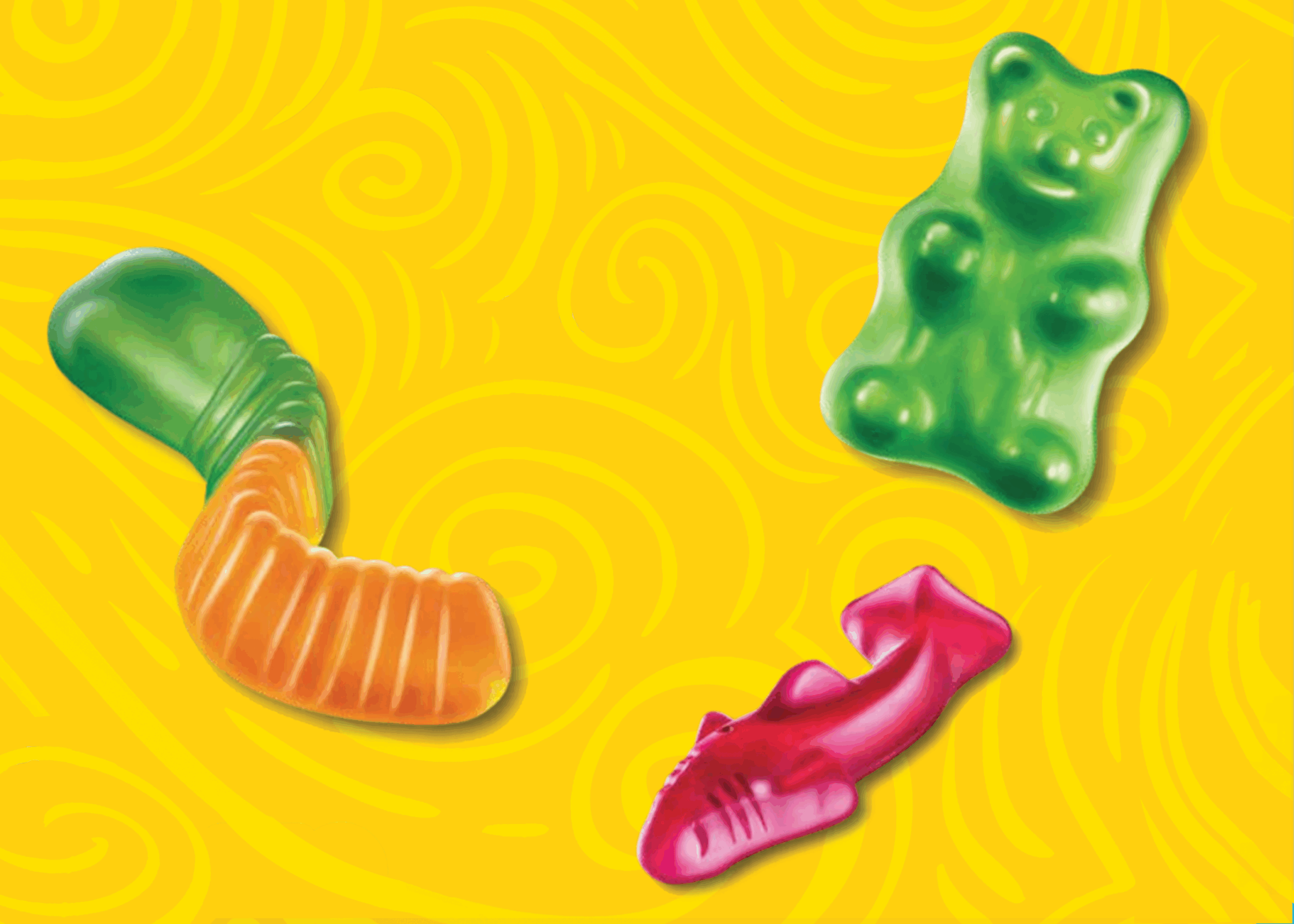 gummy bear, gummy shark, and gummy worm on a yellow swirl background